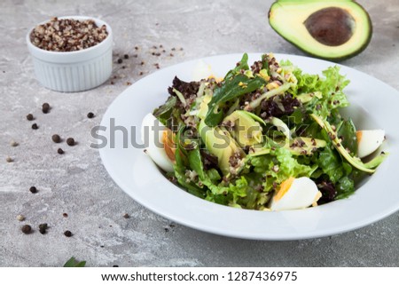 Close up view on salad with quinoa, avocado and egg on a concrete background. Healthy food. Spanish cuisine. free copy space for text, logo. Picture for recipe. Flat lay lunch. 