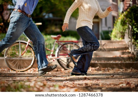 Couple running along sidewalk