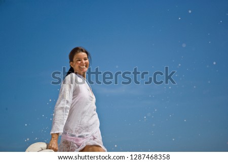 Portrait of a mid-adult woman standing in a beach.