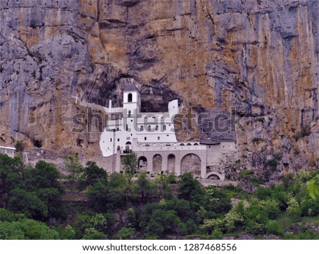 a magnificent monastery built on the mountain of the mountain surrounded by greenery