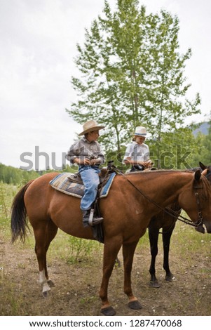 Brother and sister on horseback
