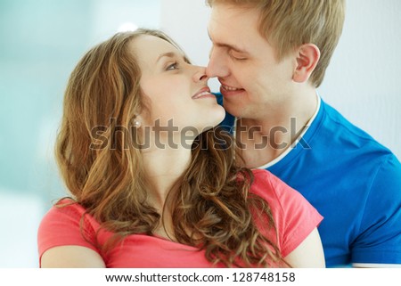 Image of happy young couple looking at one another in romantic situation