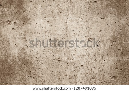
Sepia background wall. The texture of the surface of the old wall is light brown in color with many small holes, dots and scuffs. The central part is lighter, darker at the edges.