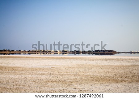 Beautiful view of the city panorama from the shore of a salty lake on the island of Cyprus