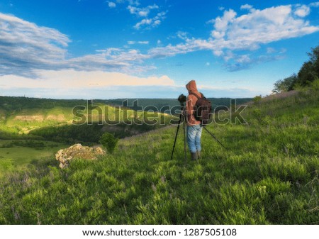 tourist on a cliff above the canyon. person on a cliff above the picturesque river. spring dawn
