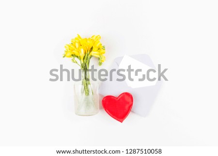 Bouquet of yellow flowers, postcard, gift, heart on white background. Flat lay, top view. Floral, spring background. Valentines Day and Mother Day background. Happy Valentine's day