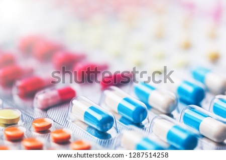 Heap of medical pills in white, blue and other colors. Pills in plastic package. Concept of healthcare and medicine. Royalty-Free Stock Photo #1287514258