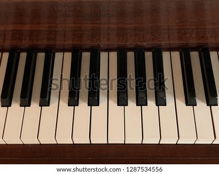 The black and white keys of an old upright piano.