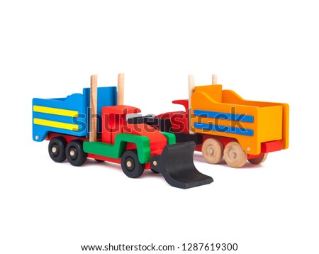Photo of a wooden trucks bulldozers with a beech trailer in different colors   on a white isolated background