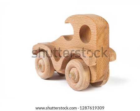 Photo of a wooden car  of beech. Toy made of wood retro car on a white isolated background