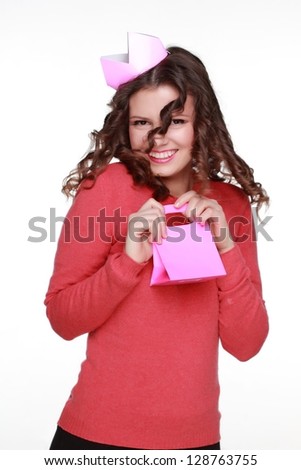 Emotional young girl opens a gift on white background on Holiday