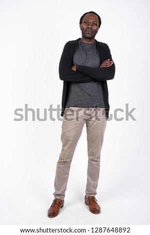 Full body shot of handsome African man with arms crossed