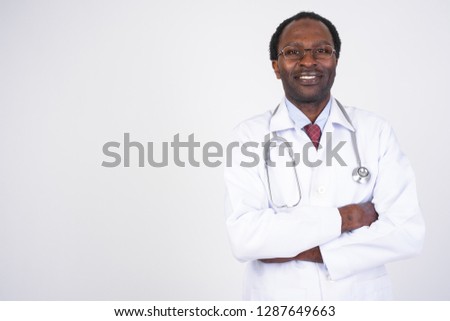 Portrait of happy African man doctor smiling with arms crossed