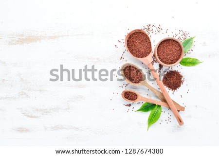 Red quinoa. On a white wooden background. Top view. Free copy space.
