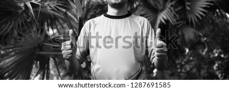 Young man showing two thumbs fingers unique black and white photo