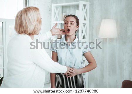 Vocal lesson. Nice talented girl singing a song while having a warm up for her voice Royalty-Free Stock Photo #1287740980