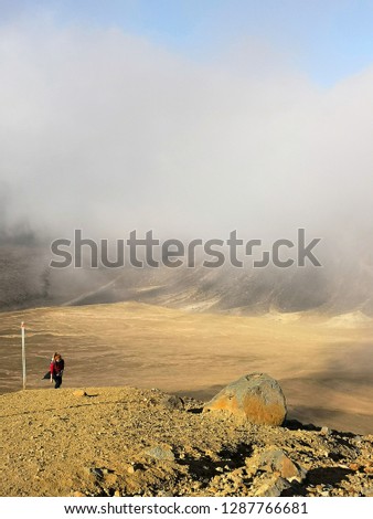 Rocky mountains terrain with person standing in the distance stock photo