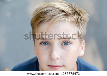 Cute Smiling Boy With Blonde Hair And Green Eyes Isolated On