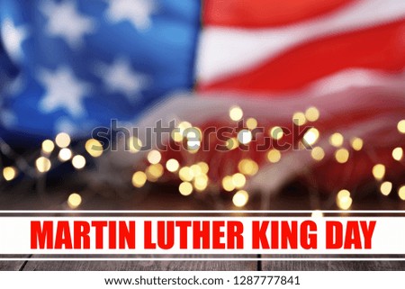 Blurred flag of USA and glowing lights. Poster for Martin Luther King Day