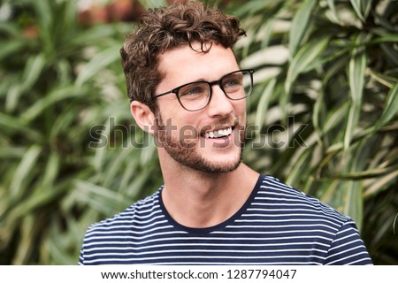 Smiling guy in glasses, looking away