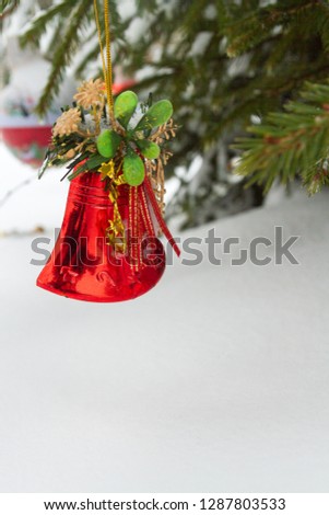 Christmas toy hanging on the tree outside in winter