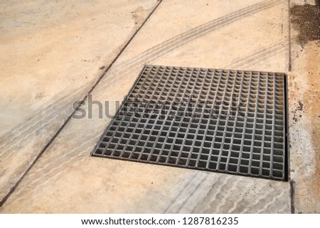 Grating on concrete floor in the factory to protect people from falling down to sewer