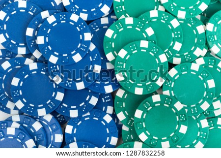 Battle Blue versus Green yin vs yang Playing Poker Chips. Abstract Pattern Background