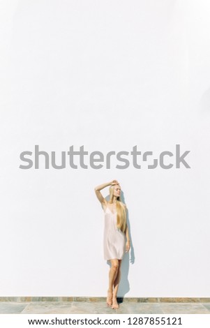 Bright morning bride in a Villa in Cyprus. Beautiful girl in a white boudoir dress.