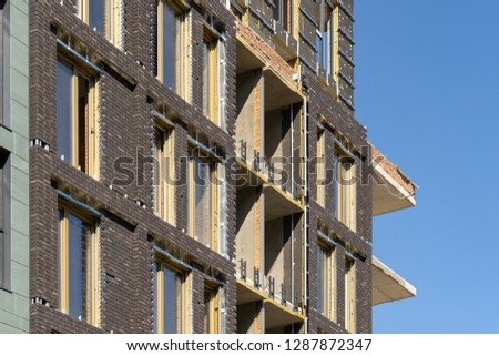 Side view photo of new brick building with special protective cold barrier against peaceful blue sky