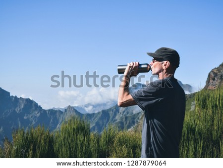 man drink water on top mountain,people outdoor lifestyle 