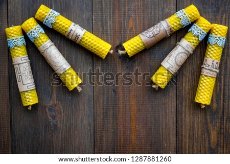 Buddhism. Candles with Yantras and mantras in sanskrit on dark wooden background top view copy space pattern