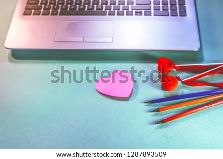 office workspace. notebook, pencils, sticker, heart symbols. valentine's day concept.