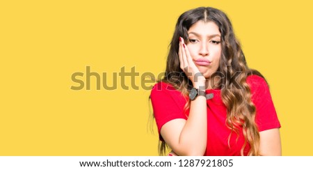 Young beautiful woman wearing casual t-shirt thinking looking tired and bored with depression problems with crossed arms.