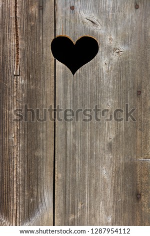 Old wooden door with heart, vertical