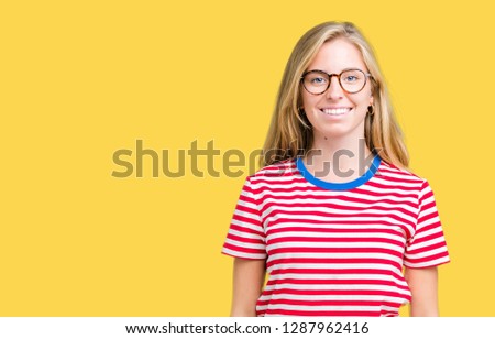 Beautiful young woman wearing glasses over isolated background with a happy and cool smile on face. Lucky person.