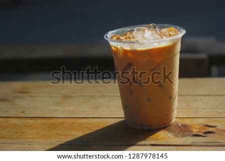 Ice coffee latte on wooden table in morning day