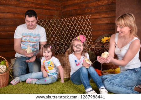 
dad, mom and two beautiful girls take pictures in the studio with chickens
