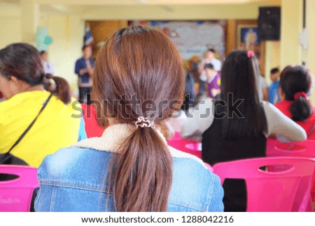 the belaying hair on head of Asian girl with Plastic band 
