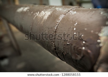 Restoration of the strength characteristics of the industrial pipeline. The final composite pipe repair. Picture taken in Ukraine, Kiev region. Color image