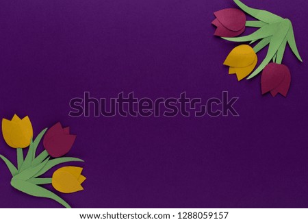 Red and yellow tulips of paper on lilac background