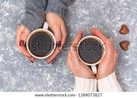 male and female hands holding cups of coffee. Selective focus. Royalty-Free Stock Photo #1288073827