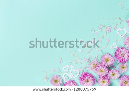 Flowers composition with hearts and petals on a pastel background