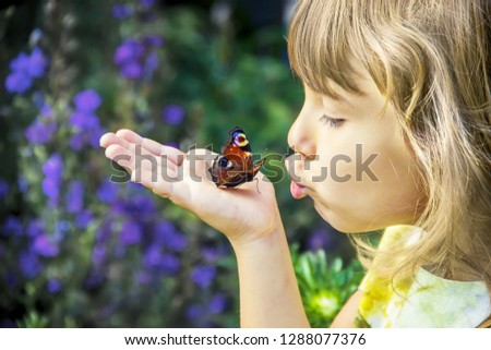 child with a butterfly in his hands. Selective focus. Royalty-Free Stock Photo #1288077376