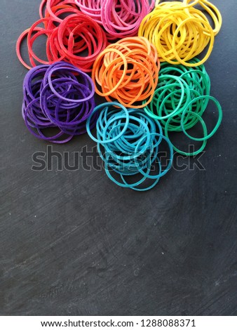 Bright Color of Rubber Bands on Blackboard