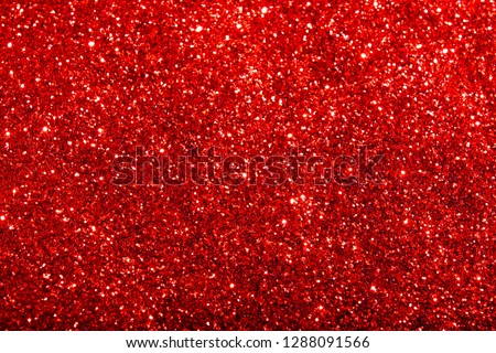 Red glitter texture. Festive sparkling sequins background closeup.