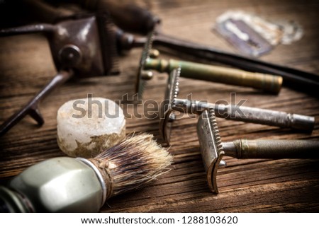 Vintage barber shop tools on old wooden background. Small depth of field.