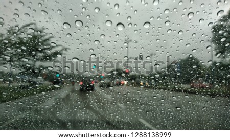 Raindrops on the windshield while driving on a rainy day, 