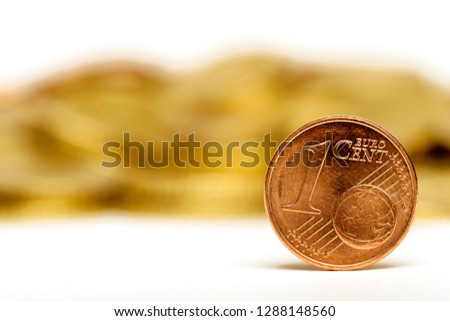Close up of One Euro Cent and coins on white background