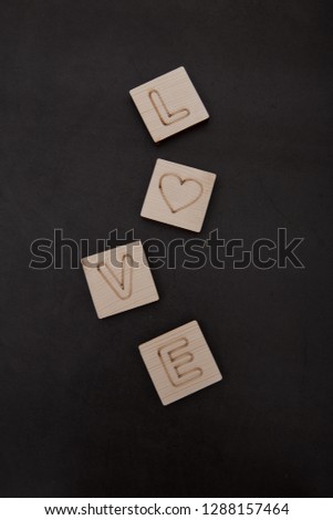 Love wooden Text dark Black Background, Valentines day. Sale banner, Photograph taken from above, top view with copy space