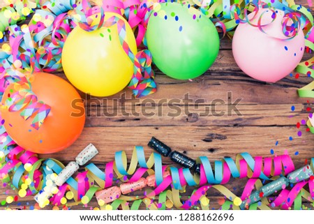 beautiful colorful background with confetti and airballoon and streamer streamers on rustical wooden background table with space